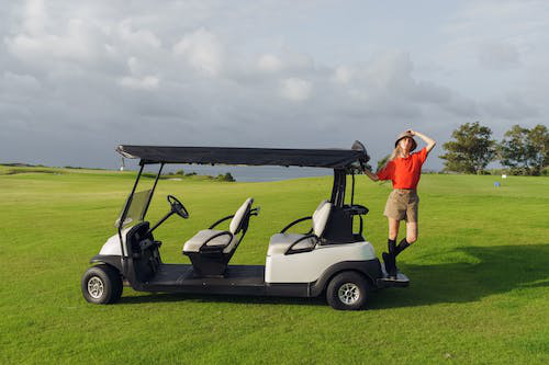 A person buying a battery cable for golf carts in a field. 