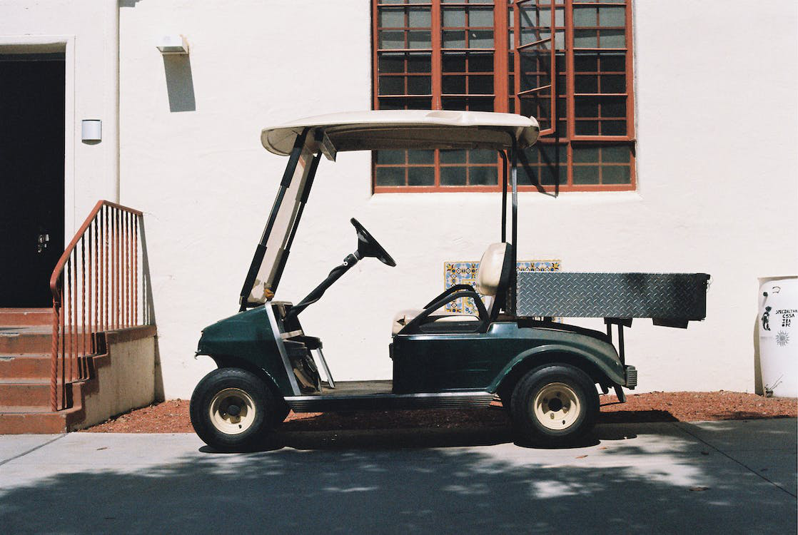 A golf cart with gas engine parts