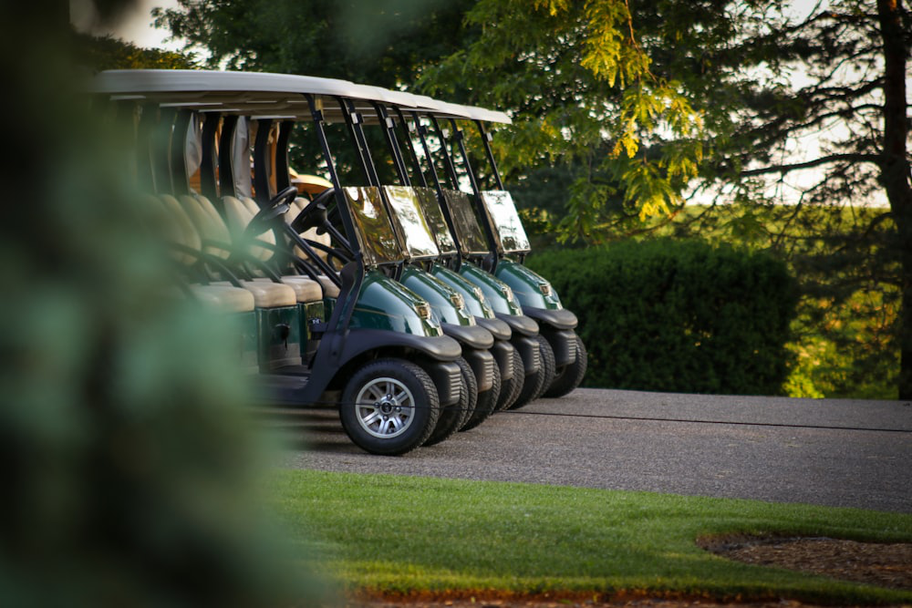 Multiple electric golf carts parked on the course
