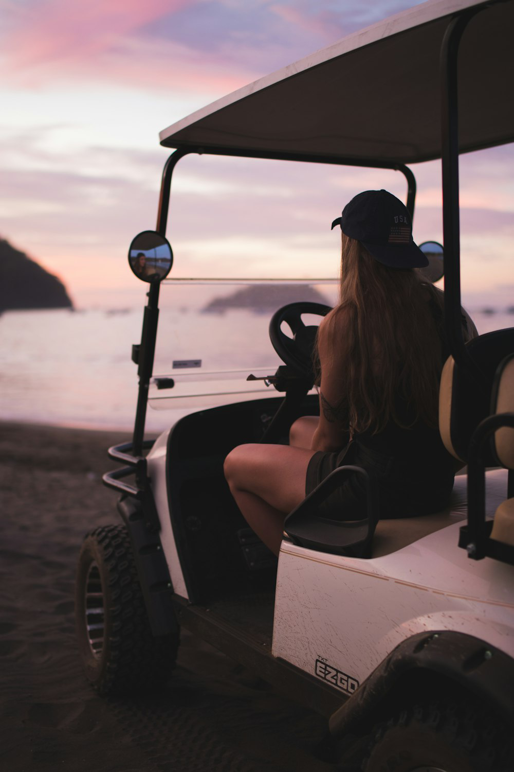 A person in the golf cart at the beach