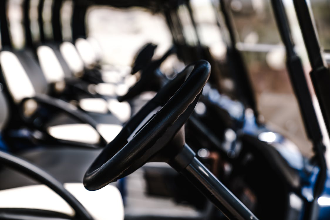 Select-focus photo of a golf cartsteering
