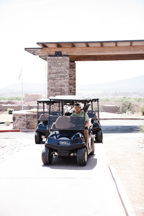 A golfer riding a Club Car